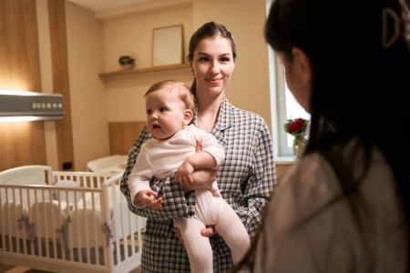 pediatrician-examining-child-in-mother-arms-during-2024-10-20-23-45-47-utc.jpg